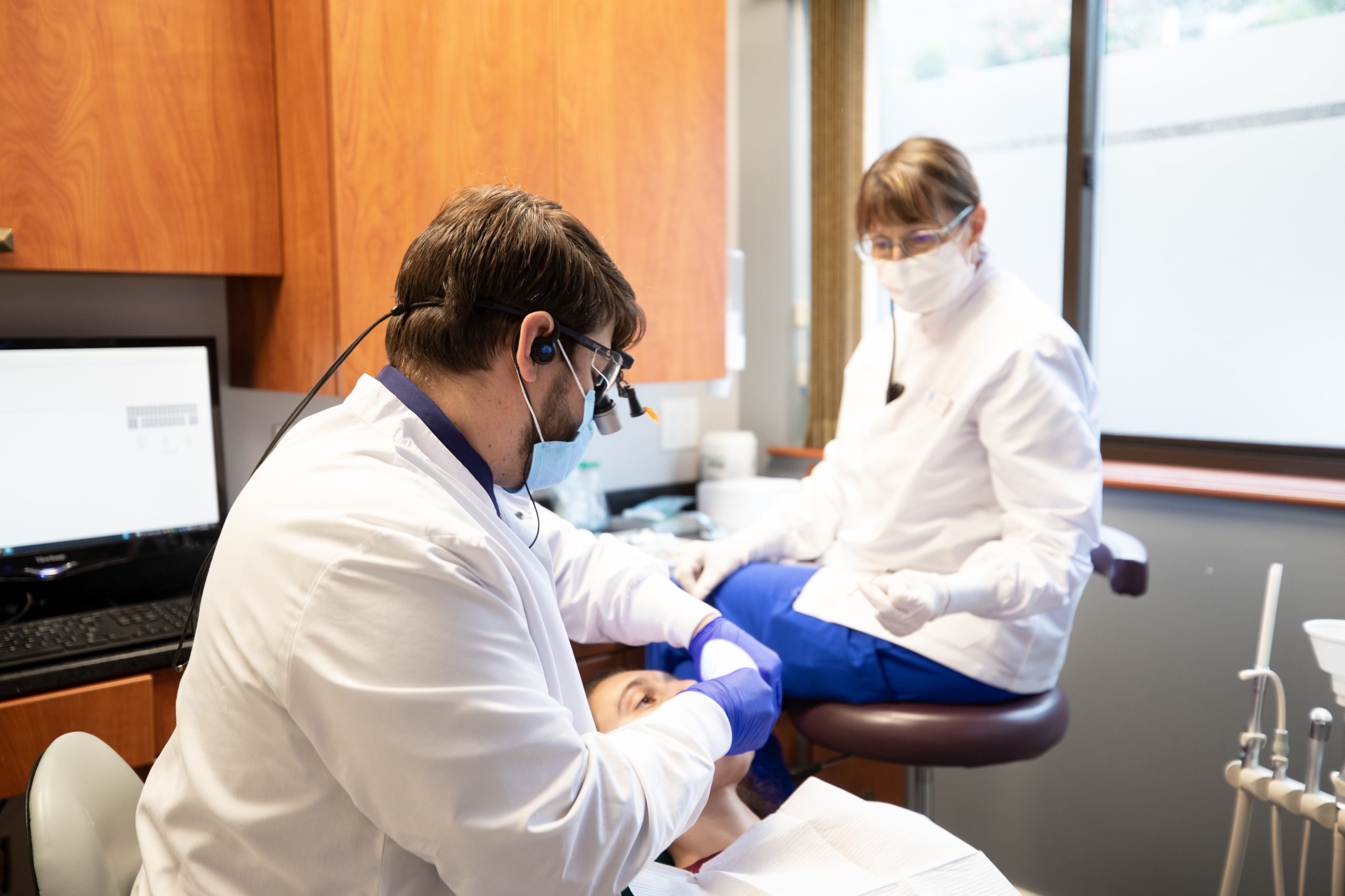 Dentist performing emergency dental care on patient in Wakefield, MA