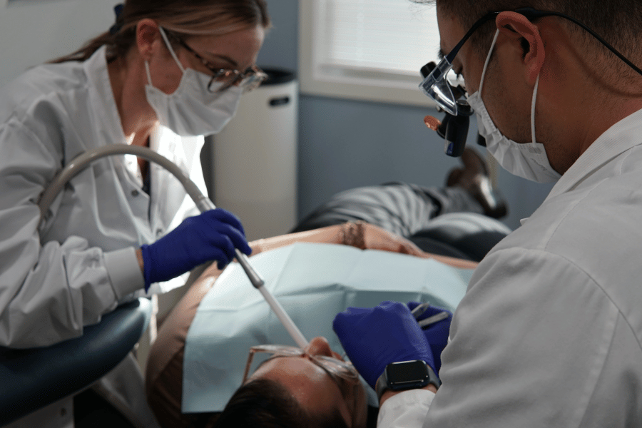 Dentist providing patient care during a dental procedure at Future of Dentistry in Billerica